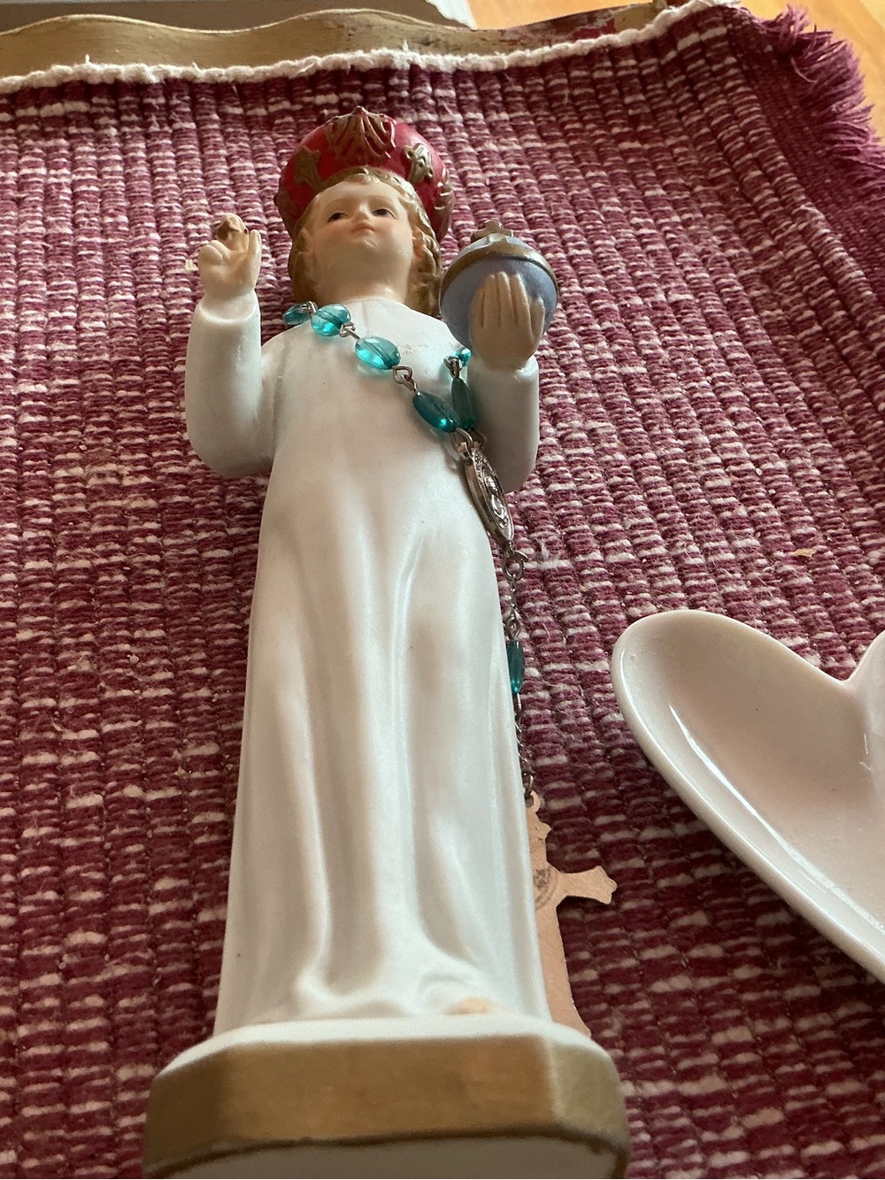 Infant of Prague statue with Rosary beads and heart shaped dish